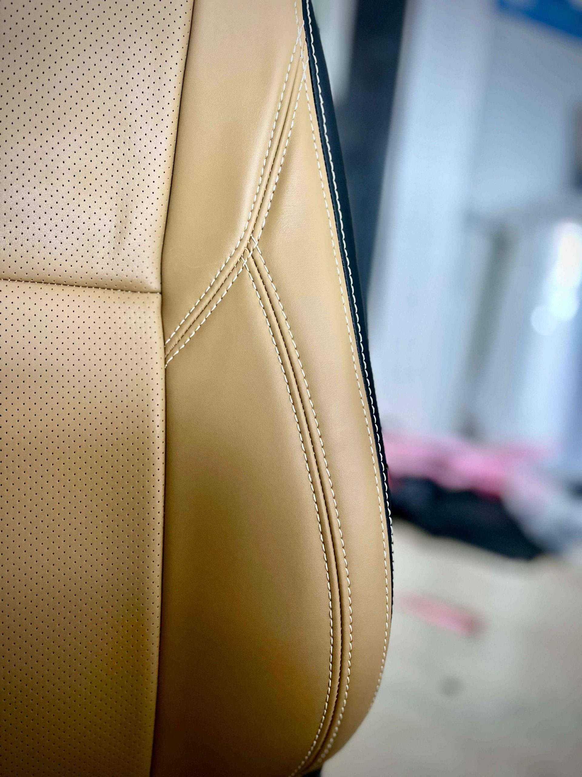 Close-up view of corner stitches on a colorful car seat cover